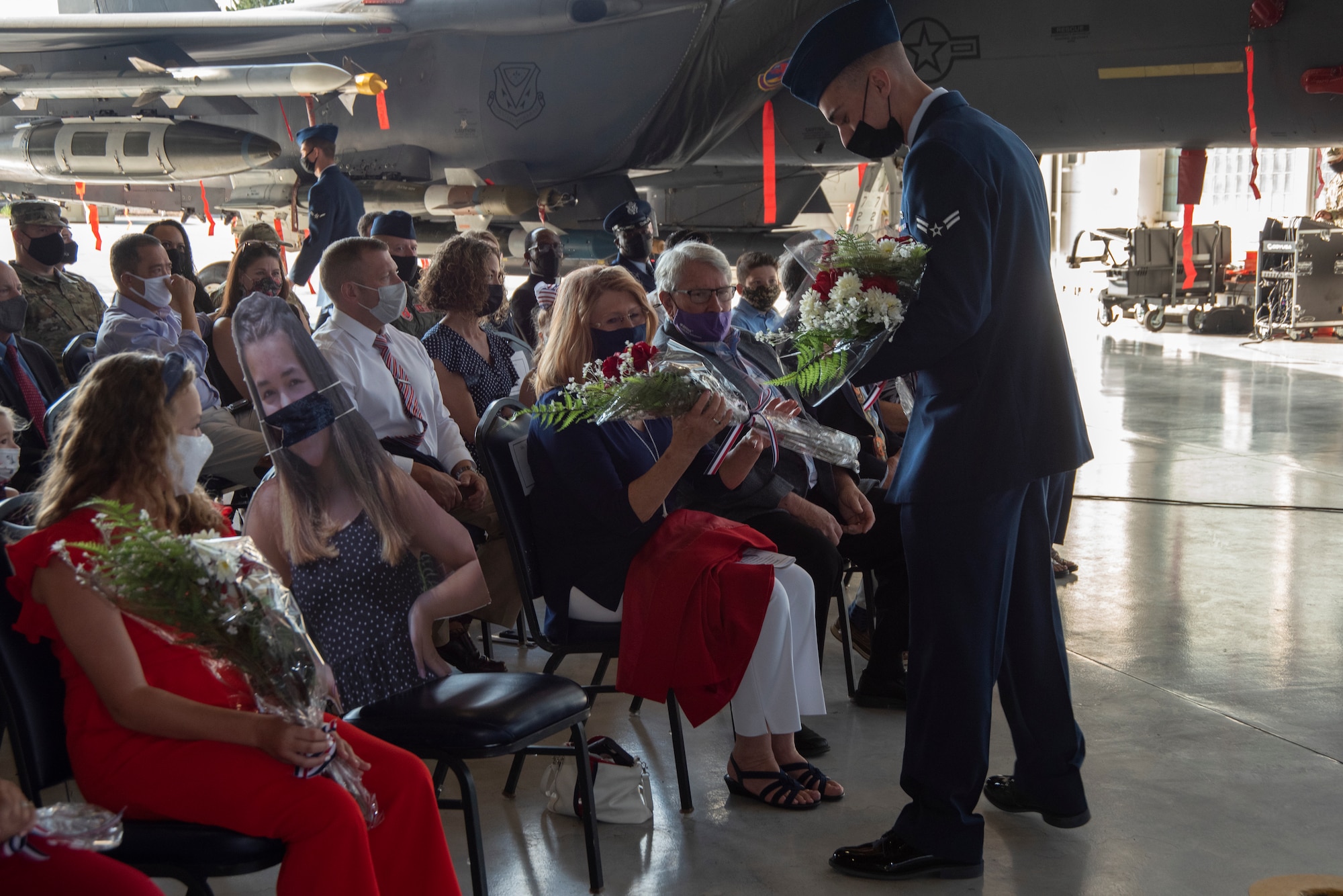 Col. Ernesto M. DiVittorio's family receives flowers during an assumption of command ceremony.