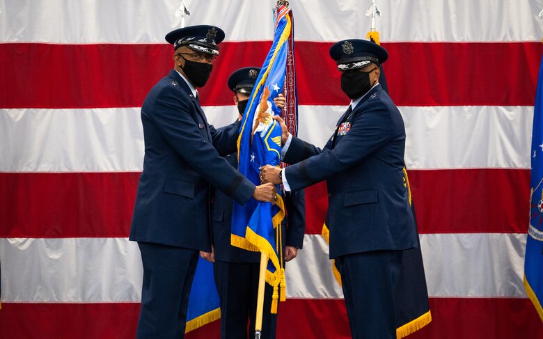 Gen. Anthony Cotton, right, incoming Air Force Global Strike Command commander, receives the guidon from Air Force Chief of Staff Gen. CQ Brown, Jr., left, during the AFGSC change of command ceremony at Barksdale Air Force Base, Louisiana, Aug. 27, 2021. The passing of a unit's guidon symbolizes a transfer of command. (U.S. Air Force photo by Senior Airman Jacob B. Wrightsman)
