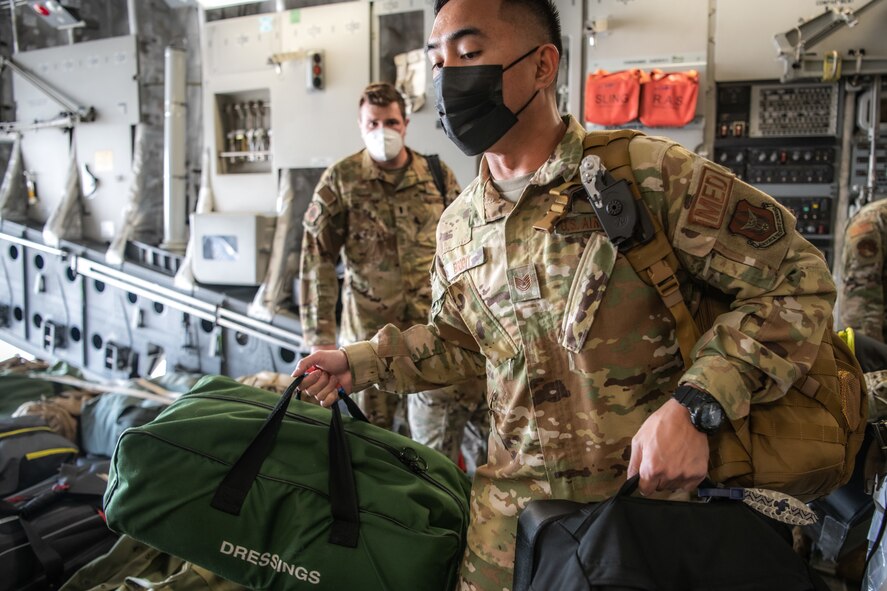 A Reserve Citizen Airman from the 349th Air Mobility Wing at Travis Air Force Base, California, board a C-17 Globemaster III prior to a mission supporting the Afghanistan evacuation, Aug. 24, 2021. The 349th AMW is providing rapid global mobility to assist the U.S. State Department in the safe evacuation of Americans and allied civilian personnel from Afghanistan