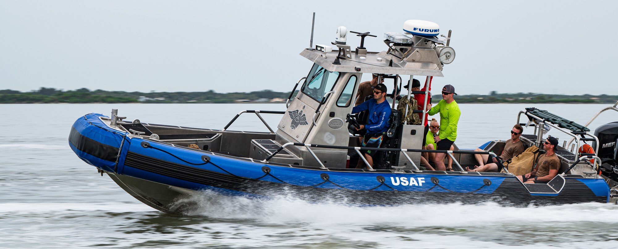 Photo of Airmen driving a boat