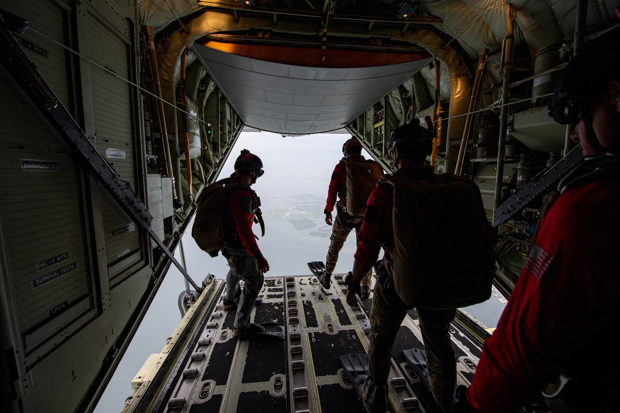 Photo of Airmen preparing to jump off an aircraft