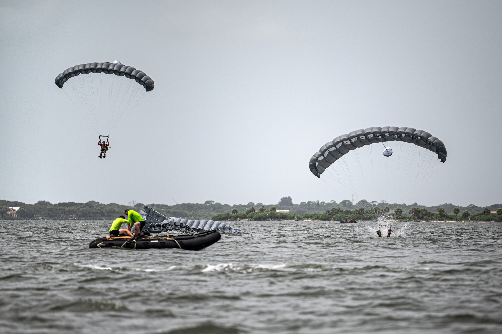 Photo of Airmen parachuting into water