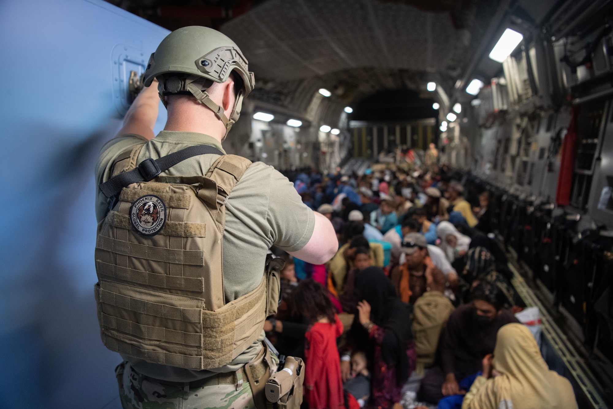 A U.S. Air Force security forces raven, assigned to the 816th Expeditionary Airlift Squadron, maintains security aboard a U.S. Air Force C-17 Globemaster III aircraft in support of the Afghanistan evacuation at Hamid Karzai International Airport (HKIA), Afghanistan, Aug. 24, 2021.