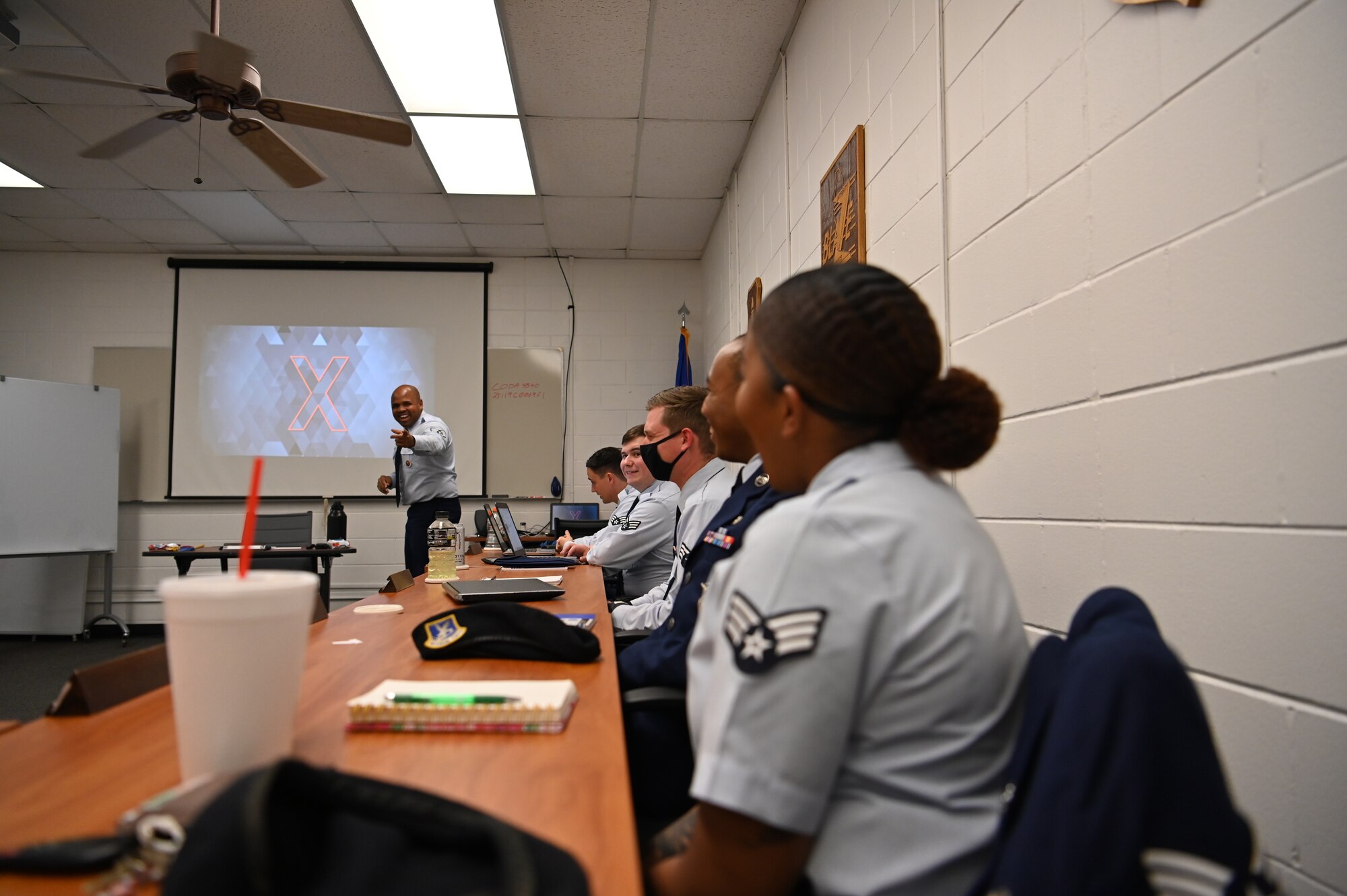 U.S. Air Force Staff Sgt. Marcos Sepulveda, 42nd Force Support Squadron, ALS Instructor, laughs with his students in the classroom, July 26 2021, on Columbus Air Force Base, Miss. Sepulveda welcomes his class back for the first time since the peak of the COVID pandemic in 2020. (U.S. Air Force photo by Second Lieutenant Peyton Craven)