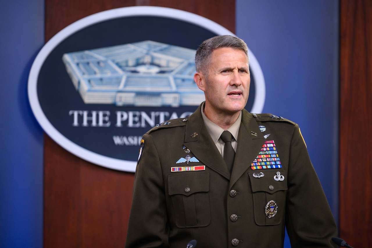 A man stands in a military uniform.