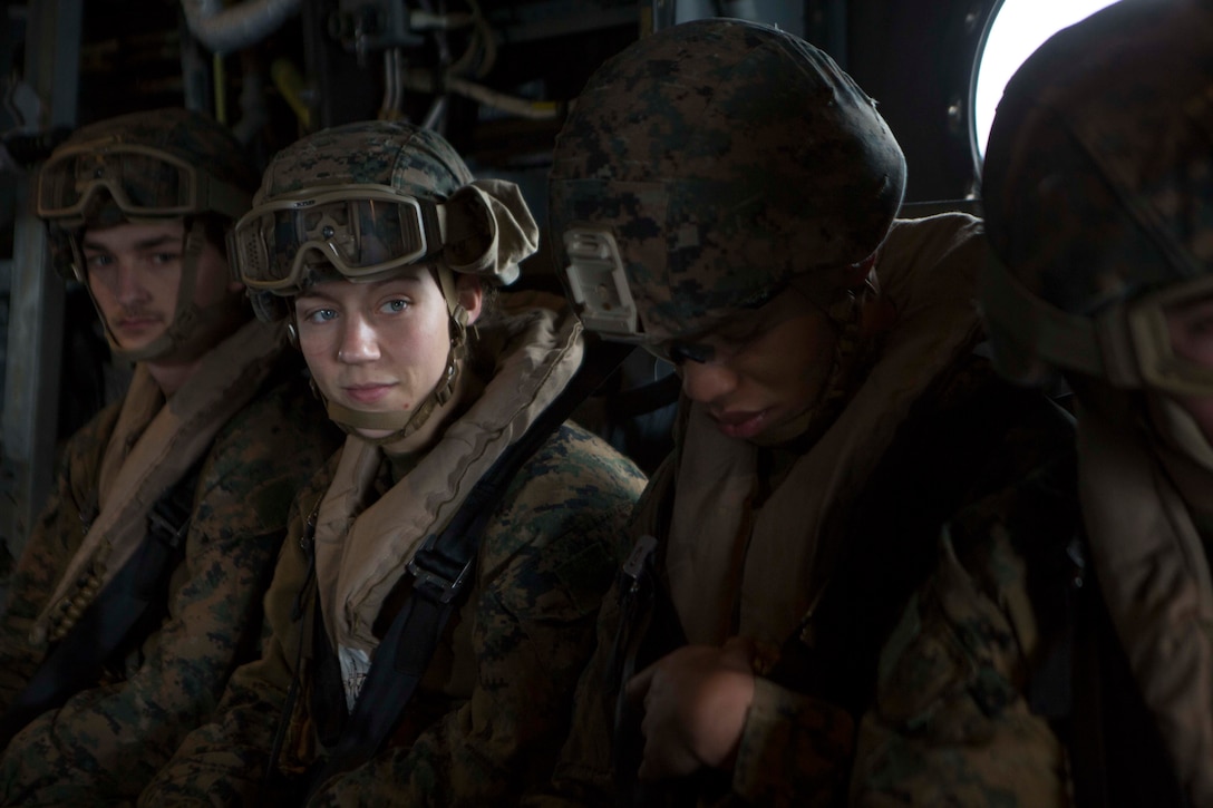 U.S. Marine Corps Corporal Nicole Gee (left middle), a maintenance technician with 24th Marine Expeditionary Unit (MEU), awaits the launch of an MV-22B Osprey during an en route care exercise aboard the Wasp-class amphibious assault ship USS Iwo Jima (LHD 7), April 5, 2021.