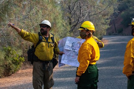 Lt. Gen. Laura J. Richardson, commanding general of U.S. Army North (Fifth Army) and the Joint Forces Land Component Command, is briefed by sawyers with Billings IA, a Bureau of Land Management Initial Attack crew based in Billings, Mont., at the August Complex wildland fire Sept. 15, 2020, in the Mendocino National Forest.