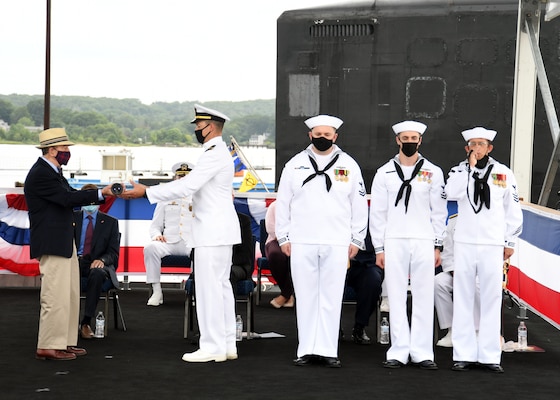 Retired Navy Capt. Albert Perry, a veteran and Vermont native, ceremonially sets the first watch with a long glass telescope during a commissioning commemoration for the USS Vermont (SSN 792) onboard Naval Submarine Base New London in Groton, Conn., Aug. 28.