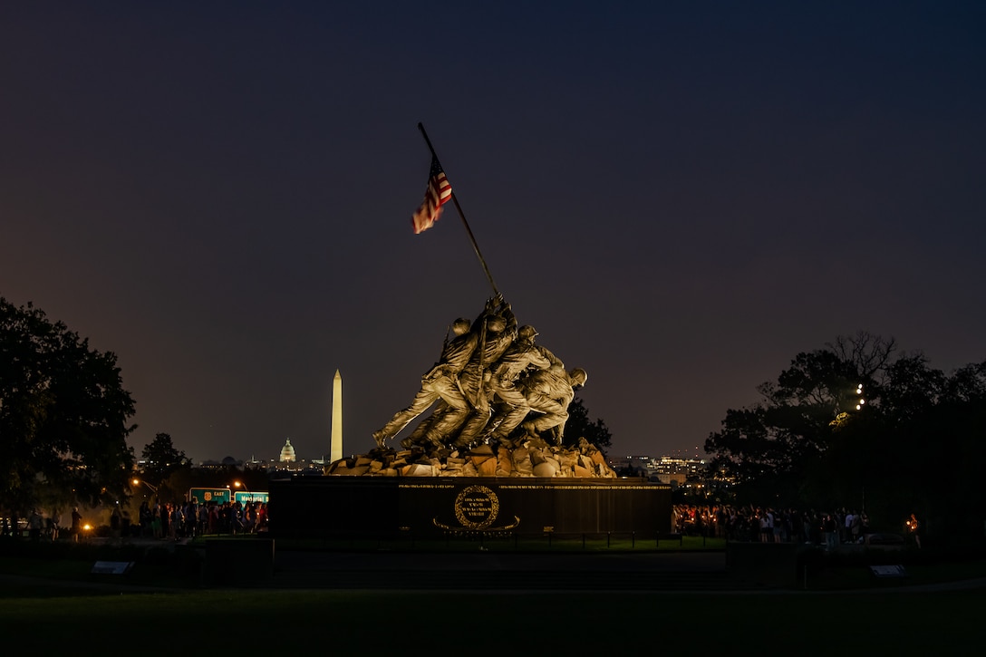 U.S. service members, veterans and people from the National Capital Region participate in a candlelight vigil at the United States Marine Corps War Memorial on Aug. 28, 2021. They come together to honor the 13 service members lives lost in the Aug. 26 enemy attack of Hamid Karzai International Airport in Kabul, Afghanistan.