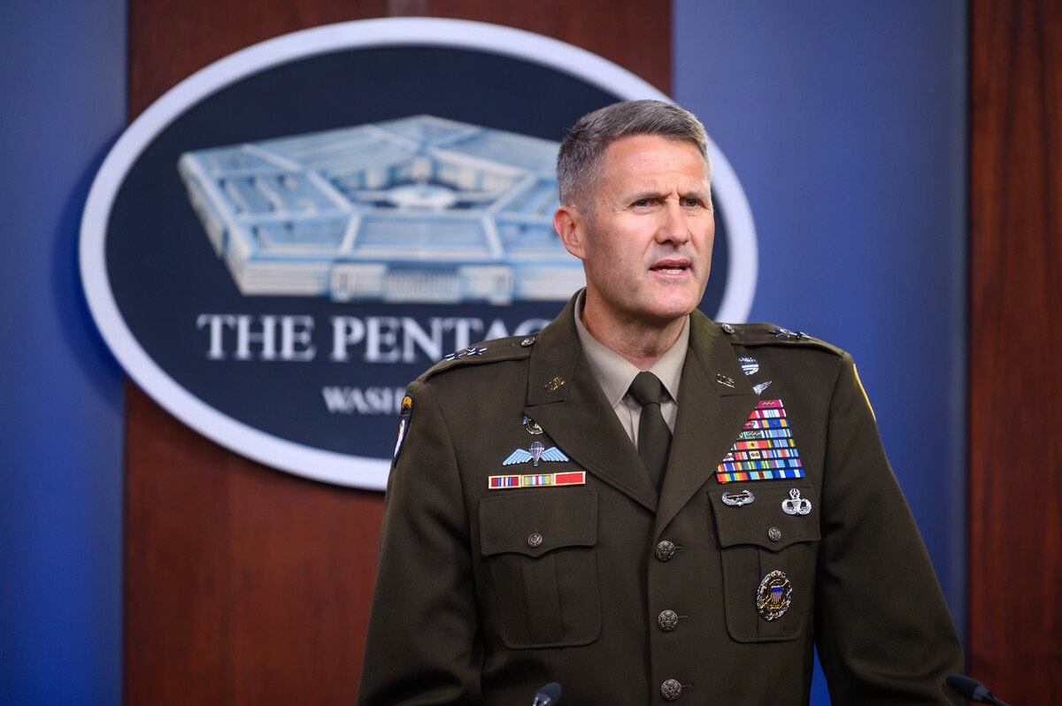 A man stands in a military uniform.