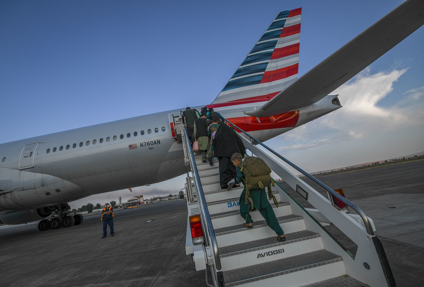 Evacuees from Afghanistan board a Boeing 777 bound for the United States from Naval Air Station Sigonella, Aug. 28, 2021. NAS Sigonella is currently supporting the Department of State mission to facilitate the safe departure and relocation of U.S. citizens, Special Immigration Visa recipients, and vulnerable populations from Afghanistan.