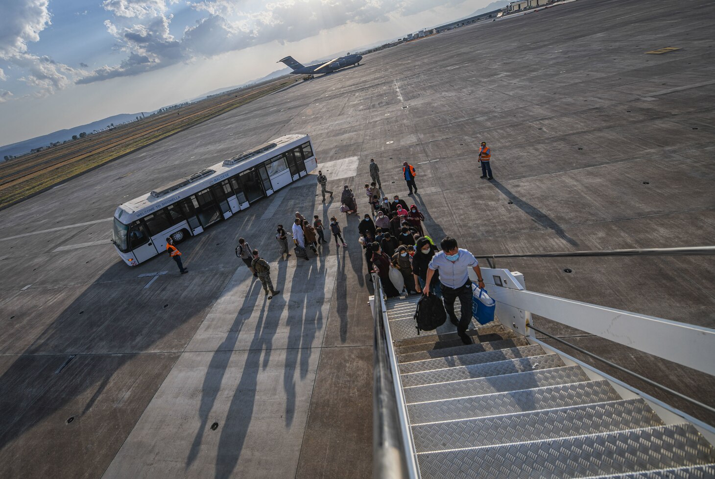 Evacuees from Afghanistan board a Boeing 777 bound for the United States from Naval Air Station Sigonella, Aug. 28, 2021. NAS Sigonella is currently supporting the Department of State mission to facilitate the safe departure and relocation of U.S. citizens, Special Immigration Visa recipients, and vulnerable populations from Afghanistan.