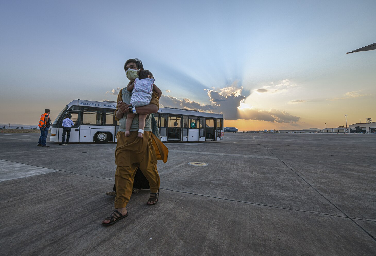 Evacuees from Afghanistan board a Boeing 777 bound for the United States from Naval Air Station Sigonella, Aug. 28, 2021. NAS Sigonella is currently supporting the Department of State mission to facilitate the safe departure and relocation of U.S. citizens, Special Immigration Visa recipients, and vulnerable populations from Afghanistan.