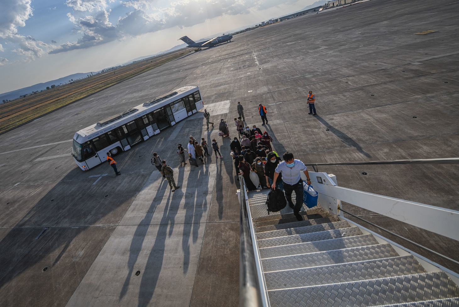 Evacuees from Afghanistan board a Boeing 777 bound for the United States from Naval Air Station Sigonella, Aug. 28, 2021. NAS Sigonella is currently supporting the Department of State mission to facilitate the safe departure and relocation of U.S. citizens, Special Immigration Visa recipients, and vulnerable populations from Afghanistan.