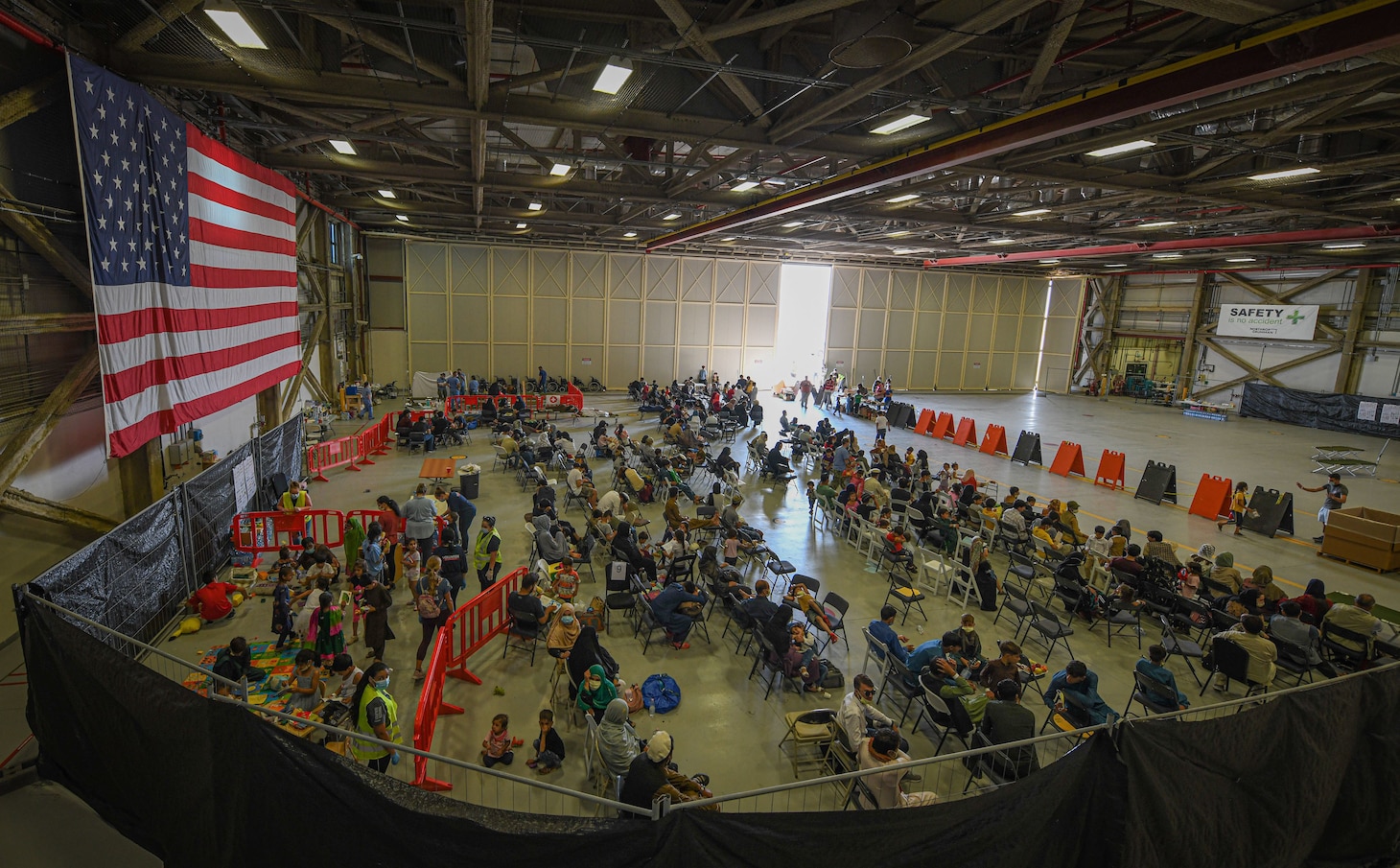 Evacuees from Afghanistan wait to board a flight bound for the United States from Naval Air Station Sigonella, Aug. 28, 2021.