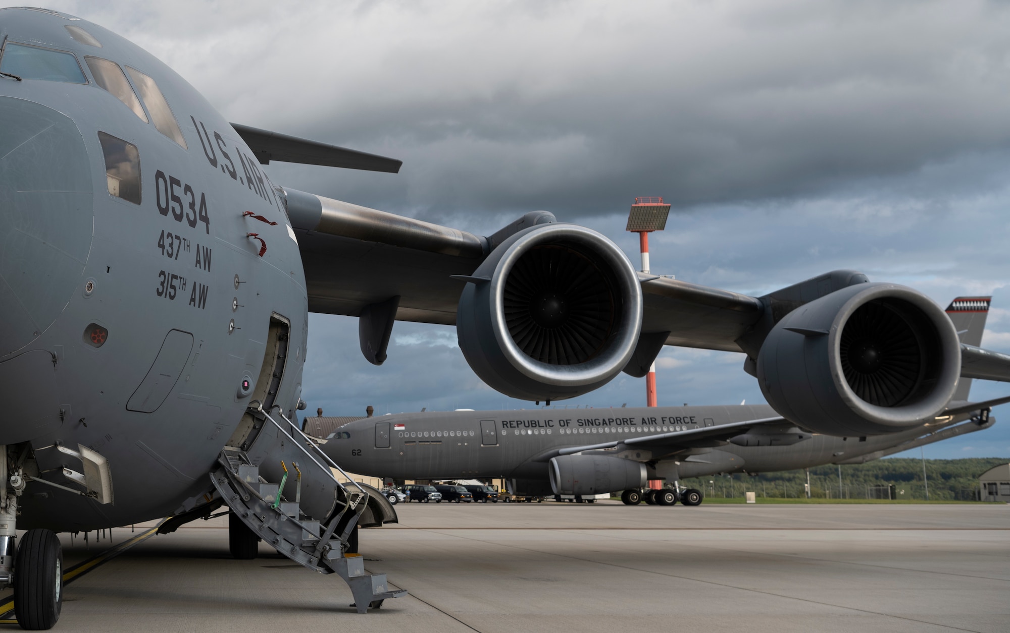 A Republic of Singapore Air Force A330 Multi-Role Tanker Transport aircraft taxis behind a U.S. Air Force C-17 Globemaster III cargo aircraft after landing on Spangdahlem Air Base, Germany, Aug. 27, 2021.
