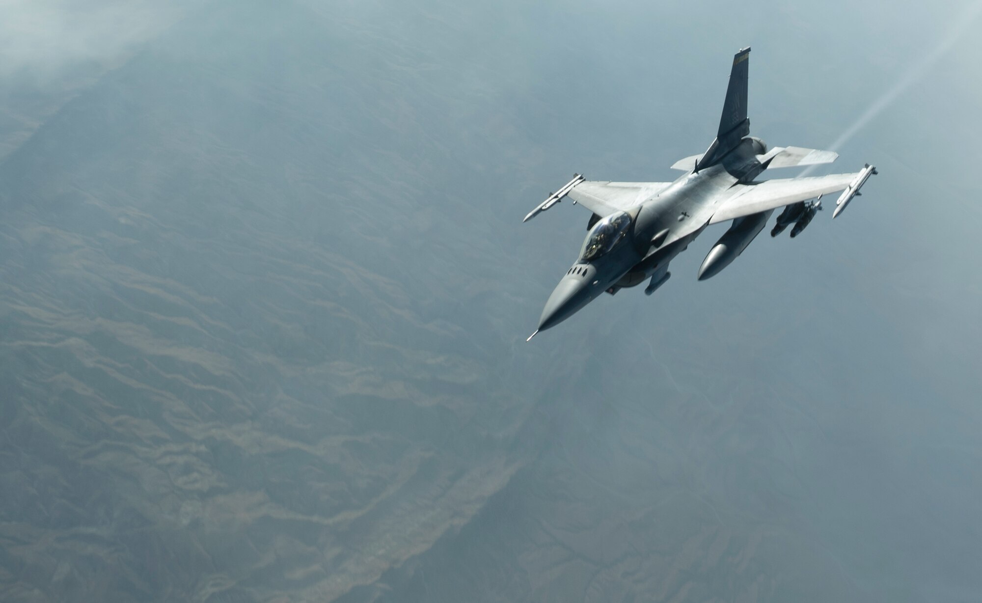Photo of a pilot flying an aircraft.