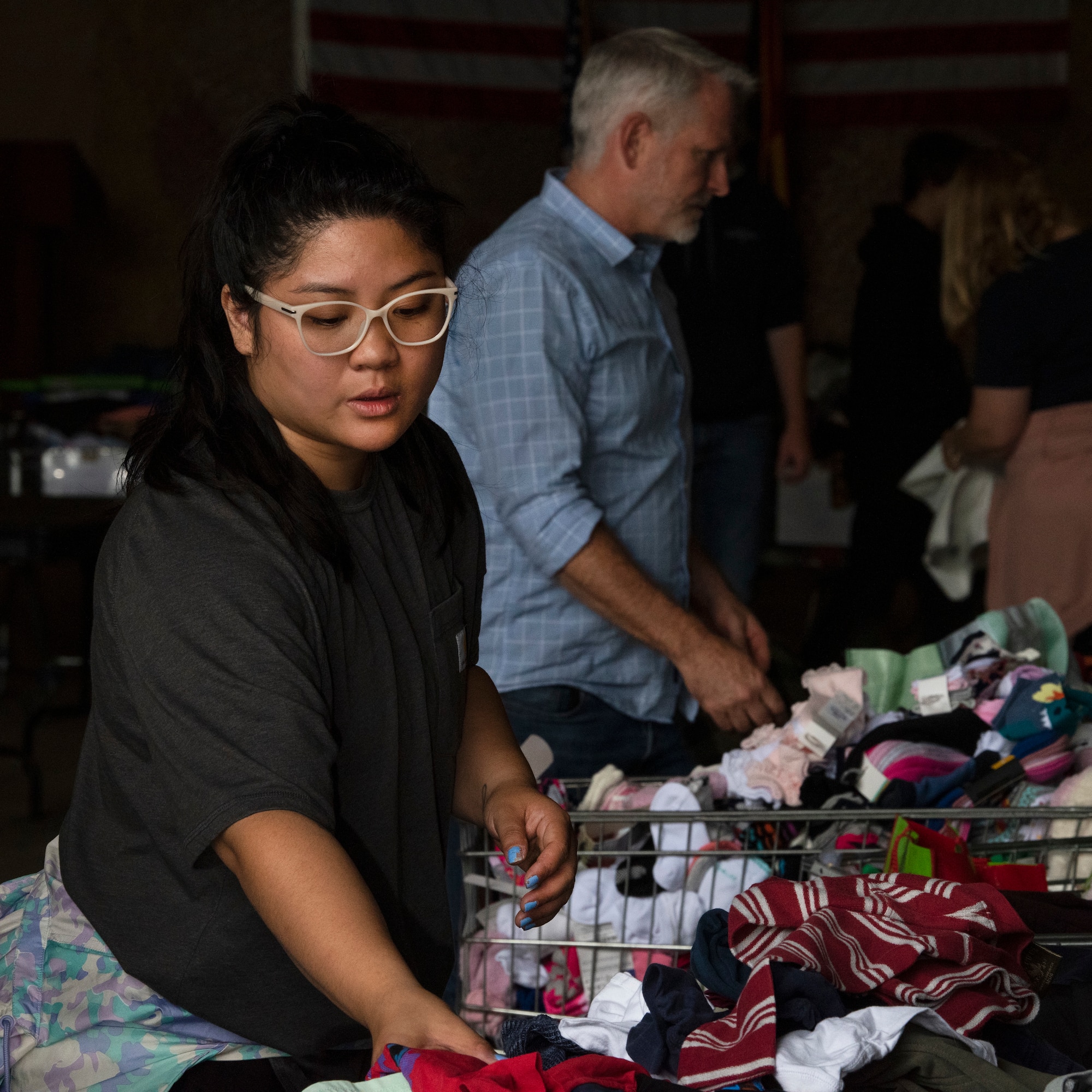 Volunteer sorts through donations.