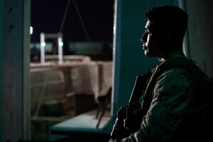 210824-N-ZA692-0755 U.S. 5TH FLEET AREA OF OPERATIONS (Aug. 24, 2021) – A U.S. Marine stands security watch in support of U.S. citizens and evacuees arriving from Afghanistan at a location in the U.S. 5th Fleet area of operations prior to onward travel to the United States. The U.S. 5th Fleet region encompasses nearly 2.5 million square miles of water area and is comprised of 20 countries.