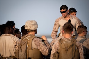 210826-N-ZA692-0259 U.S. 5TH FLEET AREA OF OPERATIONS (Aug. 26, 2021) – U.S. Marines standby to assist U.S. citizens and evacuees arriving from Afghanistan at a location in the U.S. 5th Fleet area of operations prior to onward travel to the United States. The U.S. 5th Fleet region encompasses nearly 2.5 million square miles of water area and is comprised of 20 countries.