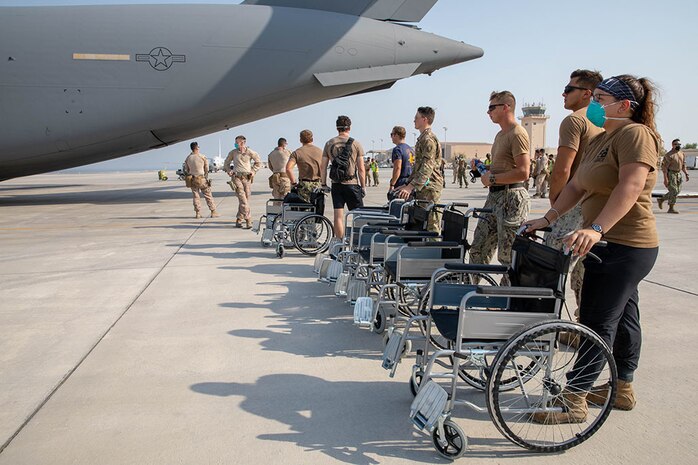 210823-A-UH336-0036 U.S. 5TH FLEET AREA OF OPERATIONS (Aug. 23, 2021) – U.S. military personnel standby to assist U.S. citizens and evacuees arriving from Afghanistan at a location in the U.S. 5th Fleet area of operations prior to onward travel to the United States. The U.S. 5th Fleet region encompasses nearly 2.5 million square miles of water area and is comprised of 20 countries. (U.S. Army photo by Spc. Joseph DeLuco)