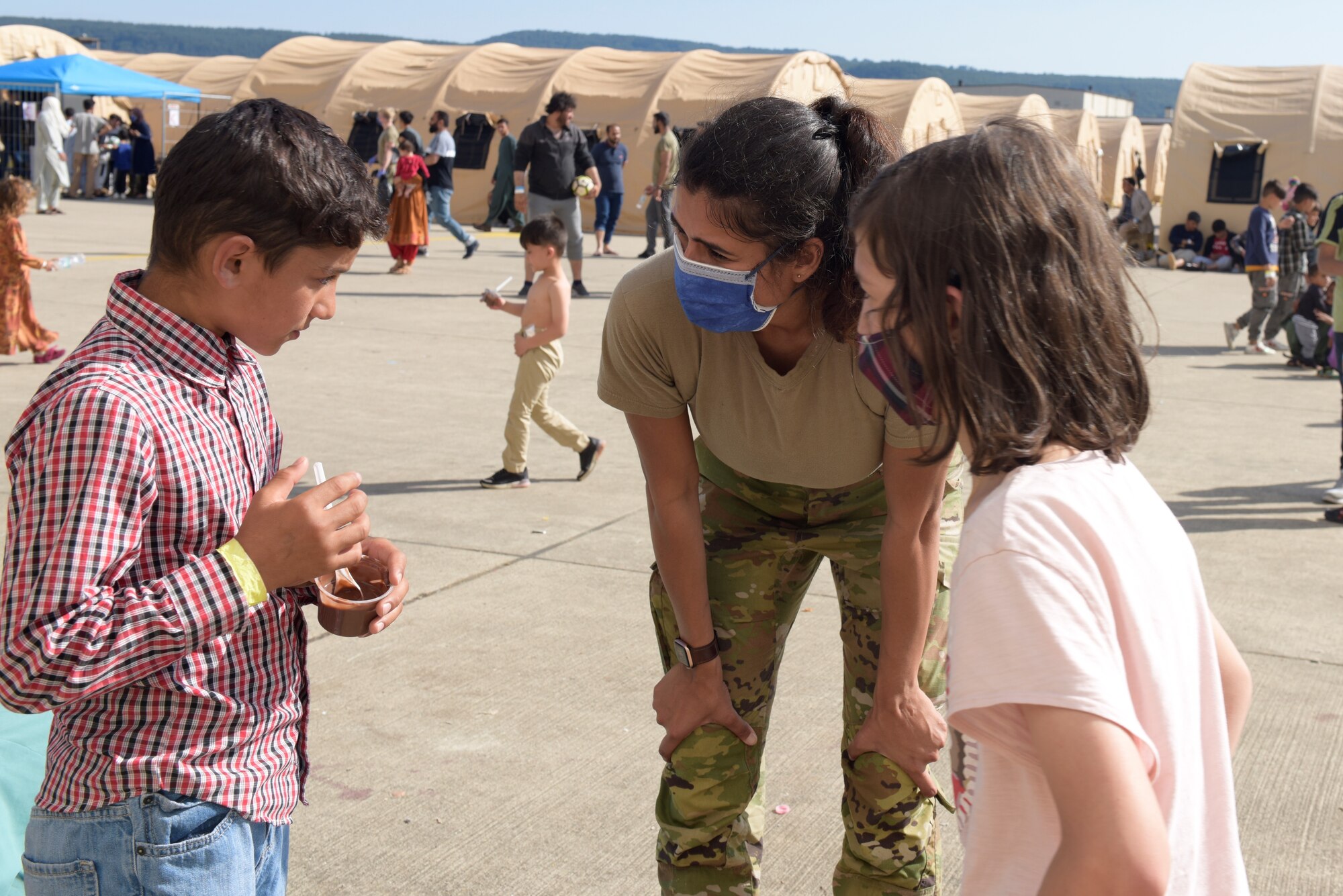 Volunteer interacts with children.
