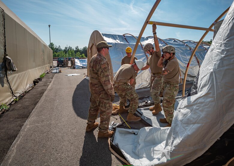 Airmen build pods.