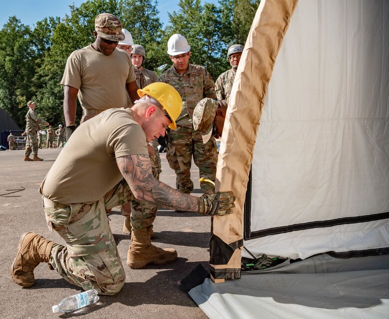 Airmen build pods.