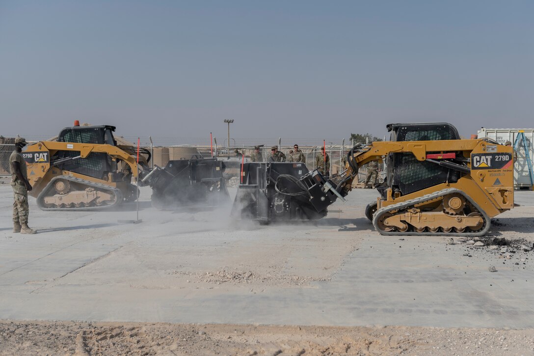Airmen with the 332nd Expeditionary Civil Engineer Squadron repair concrete during an exercise Aug. 27, 2021, in an undisclosed location somewhere in Southwest Asia. The exercise tested how quickly 332nd ECES Airmen could restore potential damage to the airfield. (U.S. Air Force photo by Senior Airman Cameron Otte)