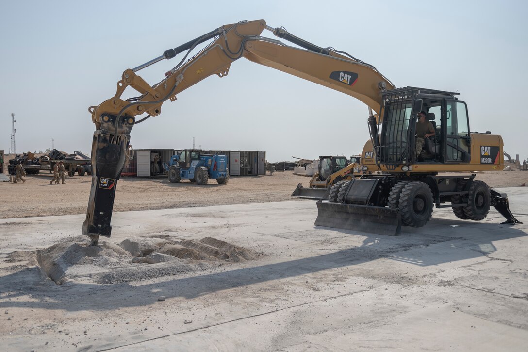 Airmen with the 332nd Expeditionary Civil Engineer Squadron repair concrete during an exercise Aug. 27, 2021, in an undisclosed location somewhere in Southwest Asia. The exercise tested how quickly 332nd ECES Airmen could restore potential damage to the airfield. (U.S. Air Force photo by Senior Airman Cameron Otte)