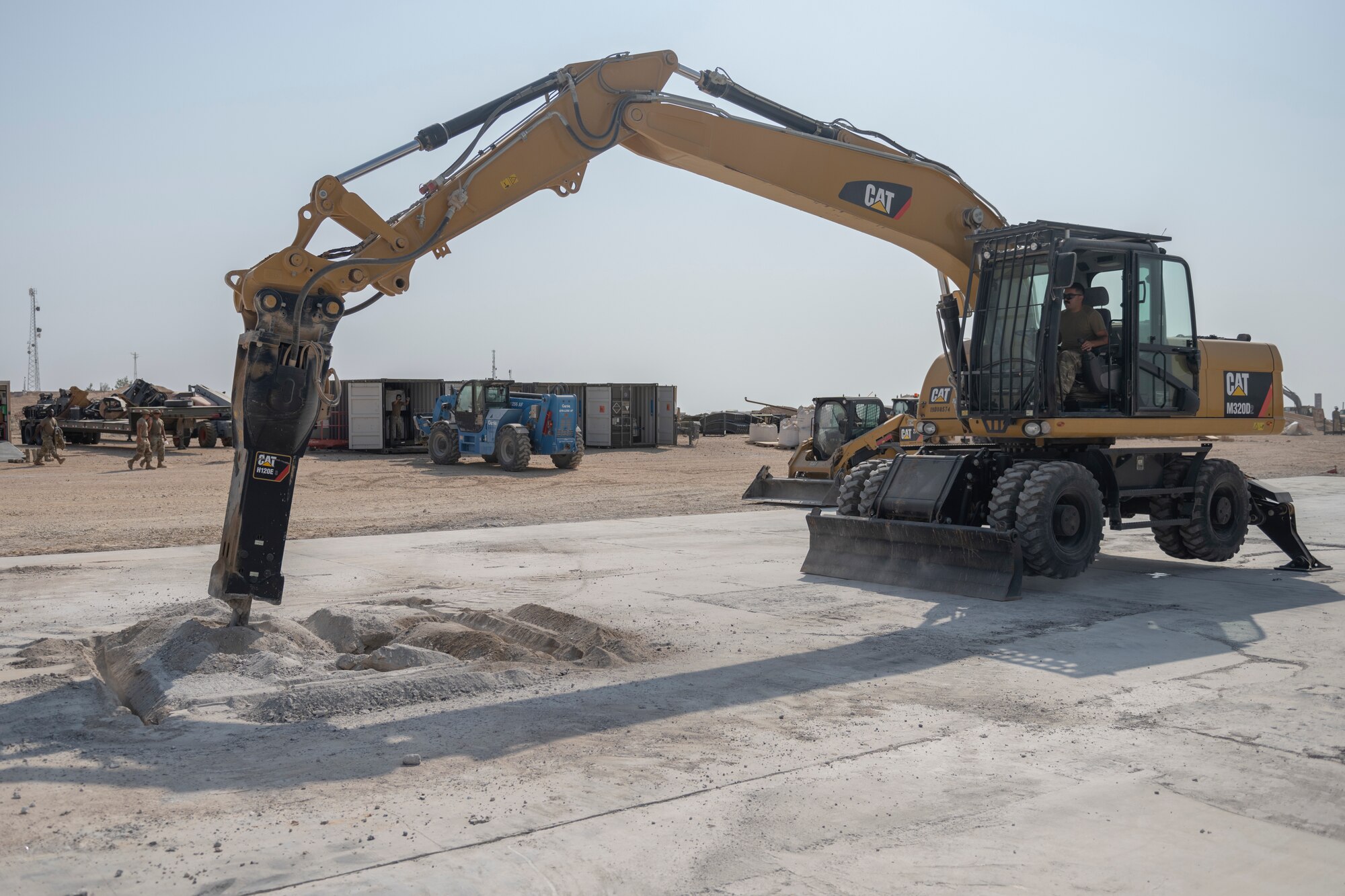 Airmen with the 332nd Expeditionary Civil Engineer Squadron repair concrete during an exercise Aug. 27, 2021, in an undisclosed location somewhere in Southwest Asia. The exercise tested how quickly 332nd ECES Airmen could restore potential damage to the airfield. (U.S. Air Force photo by Senior Airman Cameron Otte)