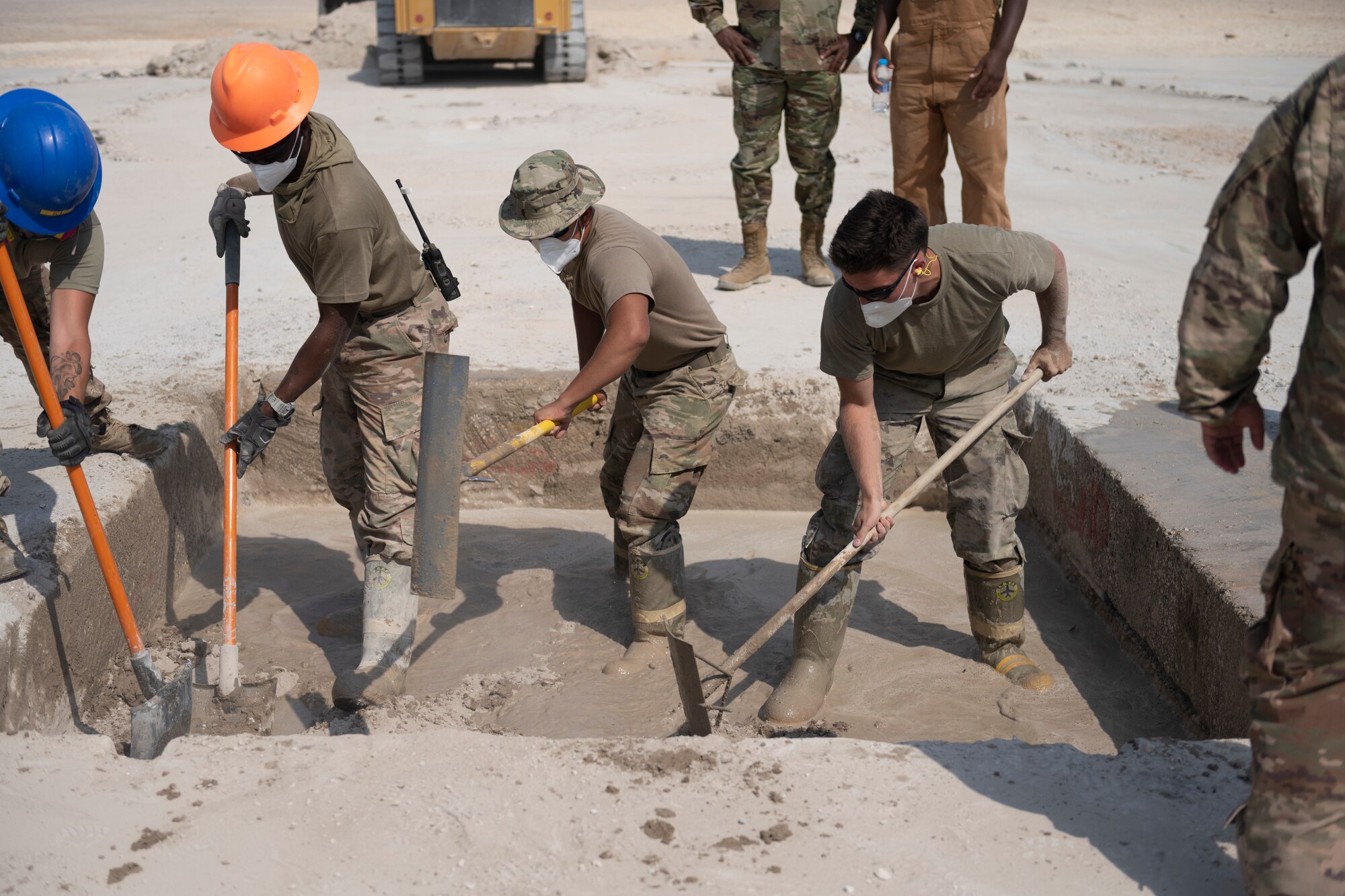 Airmen with the 332nd Expeditionary Civil Engineer Squadron repair concrete during an exercise Aug. 27, 2021, in an undisclosed location somewhere in Southwest Asia. The exercise tested how quickly 332nd ECES Airmen could restore potential damage to the airfield. (U.S. Air Force photo by Senior Airman Cameron Otte)