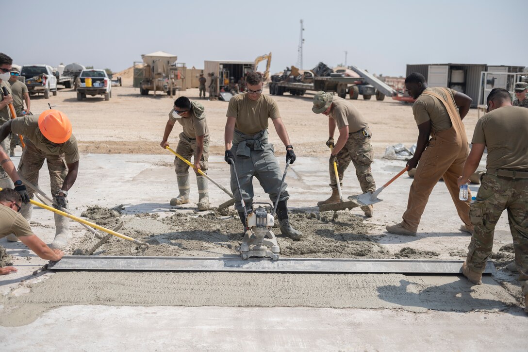 Airmen with the 332nd Expeditionary Civil Engineer Squadron repair concrete during an exercise Aug. 27, 2021, in an undisclosed location somewhere in Southwest Asia. The exercise tested how quickly 332nd ECES Airmen could restore potential damage to the airfield. (U.S. Air Force photo by Senior Airman Cameron Otte)