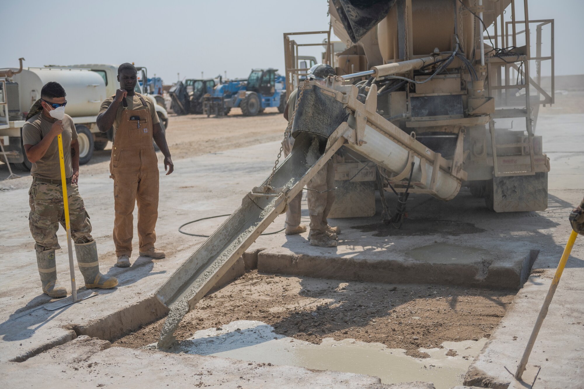 Airmen with the 332nd Expeditionary Civil Engineer Squadron repair concrete during an exercise Aug. 27, 2021, in an undisclosed location somewhere in Southwest Asia. The exercise tested how quickly 332nd ECES Airmen could restore potential damage to the airfield. (U.S. Air Force photo by Senior Airman Cameron Otte)