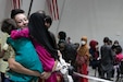 A U.S. Army Central Soldier welcomes Afghan evacuee girls with hugs during the arrival processes at Camp Buehring, Kuwait, Aug. 25, 2021. USARCENT Soldiers hit it off quickly with the children at the facility, finding ways to bring smiles and laughs through the process. (U.S. Army photo by Sgt. Marc Loi)