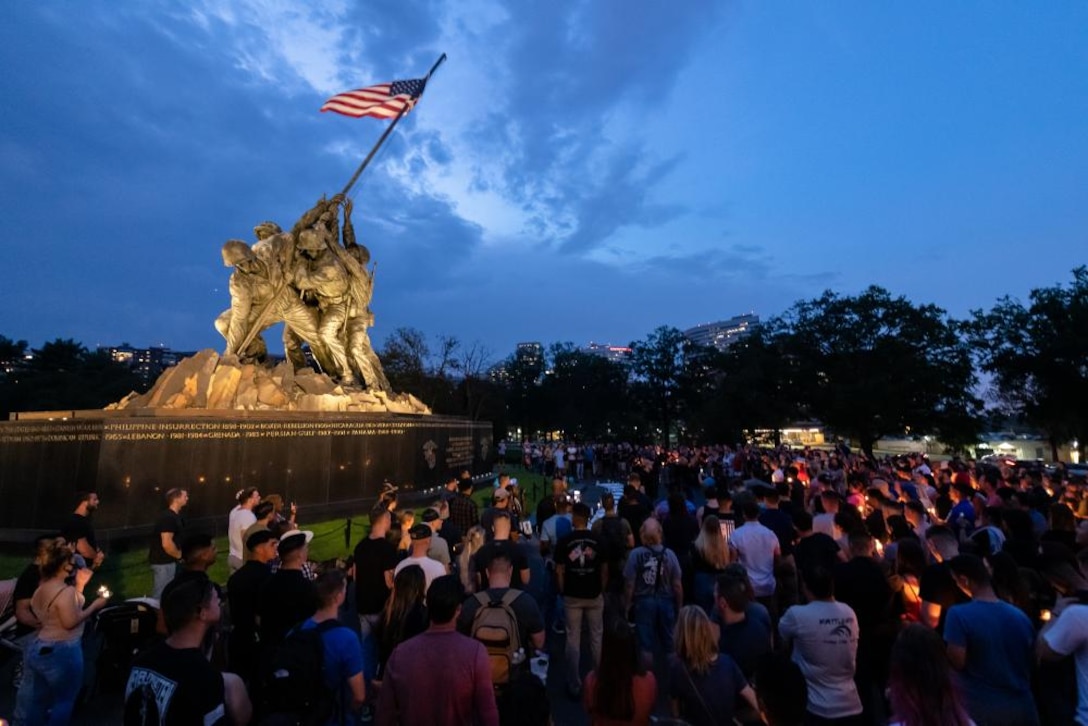 A large group of people gather at the United States Marine Corps War Memorial for a candlelight vigil, Saturday, Aug. 28, 2021, in memory of the 11 Marines, one Navy Corpsman and one U.S. Army Soldier who lost their lives on Aug. 26, 2021, during an attack in Kabul, Afghanistan.