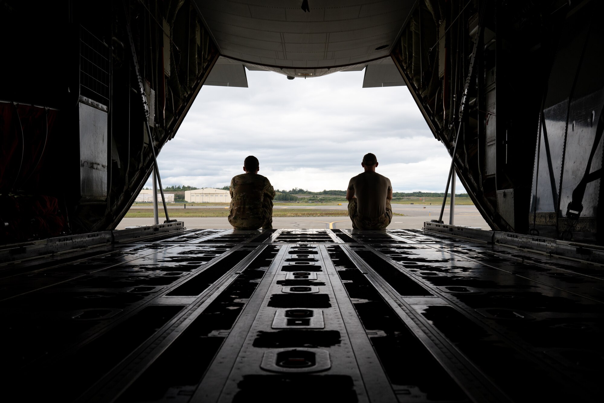 U.S. Air Force Airman 1st Class Andrew Harris, a 39th Airlift Squadron C-130J Super Hercules loadmaster from Dyess Air Force Base, Texas, and Staff Sgt. Nolan Brandt, a 39th Airlift Squadron C-130J Super Hercules instructor loadmaster from Dyess AFB, Texas, await takeoff during RED FLAG-Alaska 21-3.