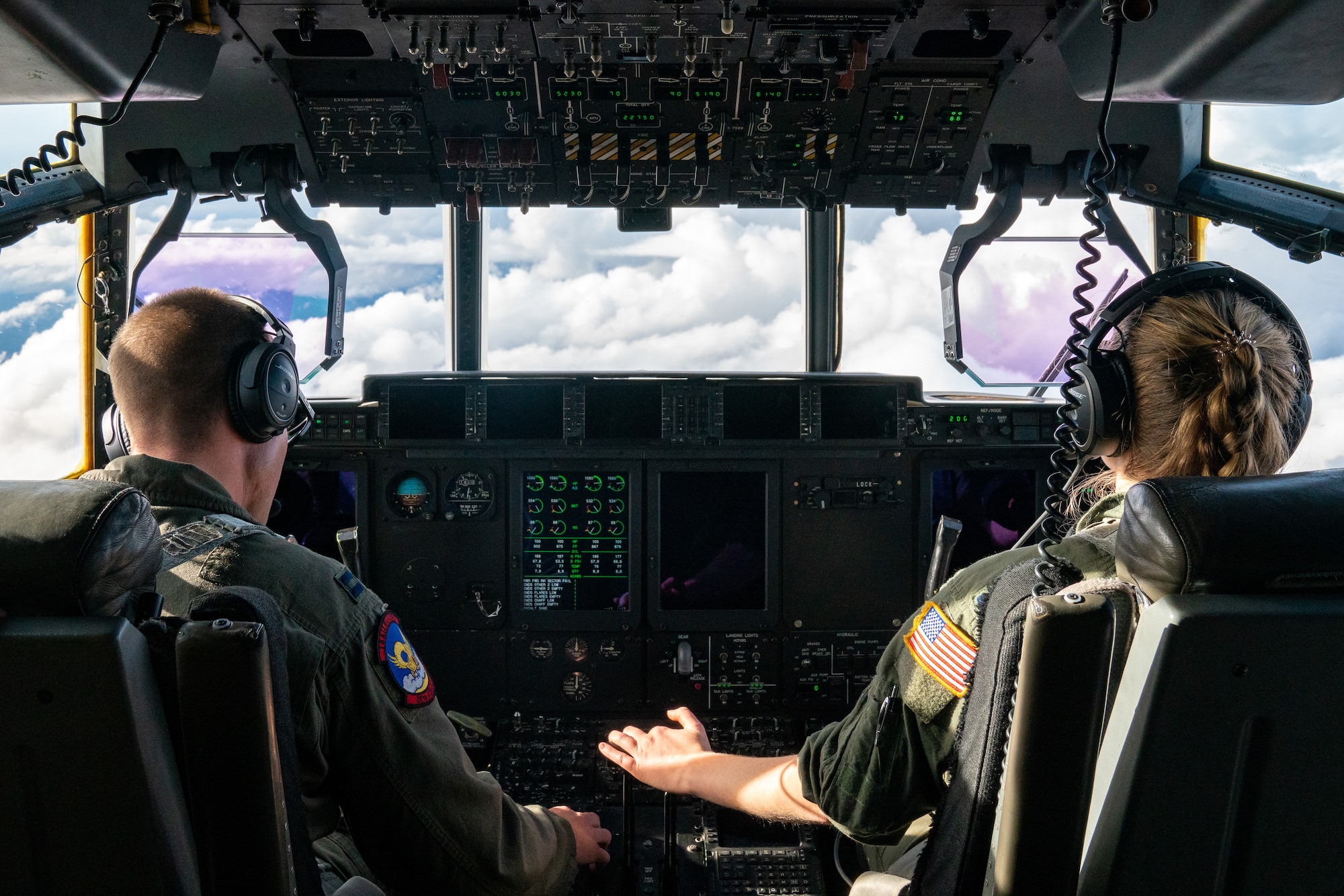 U.S. Air Force Capt. Logan Collier and 1st Lt. Emily Nole, 39th Airlift Squadron C-130J Super Hercules pilots from Dyess Air Force Base, Texas, fly over a cloud bank during a RED FLAG-Alaska 21-3 sortie.
