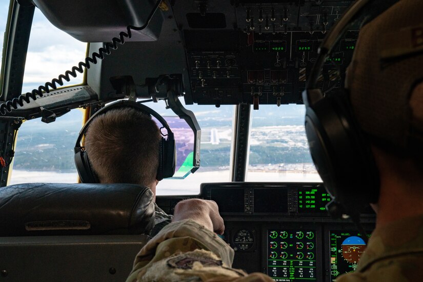 U.S. Air Force Capt. Logan Collier, a 39th Airlift Squadron C-130J Super Hercules pilot from Dyess Air Force Base, Texas, brings the aircraft in for a landing as Staff Sgt. Nolan Brandt, a 39th Airlift Squadron C-130J Super Hercules instructor loadmaster from Dyess AFB, Texas, looks on during a RED FLAG-Alaska 21-3 sortie.