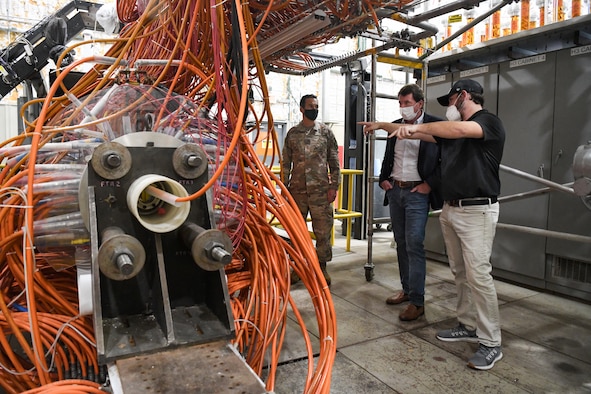 John Hile, right, an Arnold Engineering Development Complex (AEDC) test engineer, explains how an arc heater works to Sen. Bill Hagerty of Tennessee during a visit by the senator to the headquarters of AEDC, Arnold Air Force Base, Tenn., Aug. 23, 2021. Arc heaters allow for the testing of thermal protection systems in simulated environments representative of hypersonic flight. Also pictured is Col. Jeffrey Geraghty, commander, AEDC. (U.S. Air Force photo by Jill Pickett)