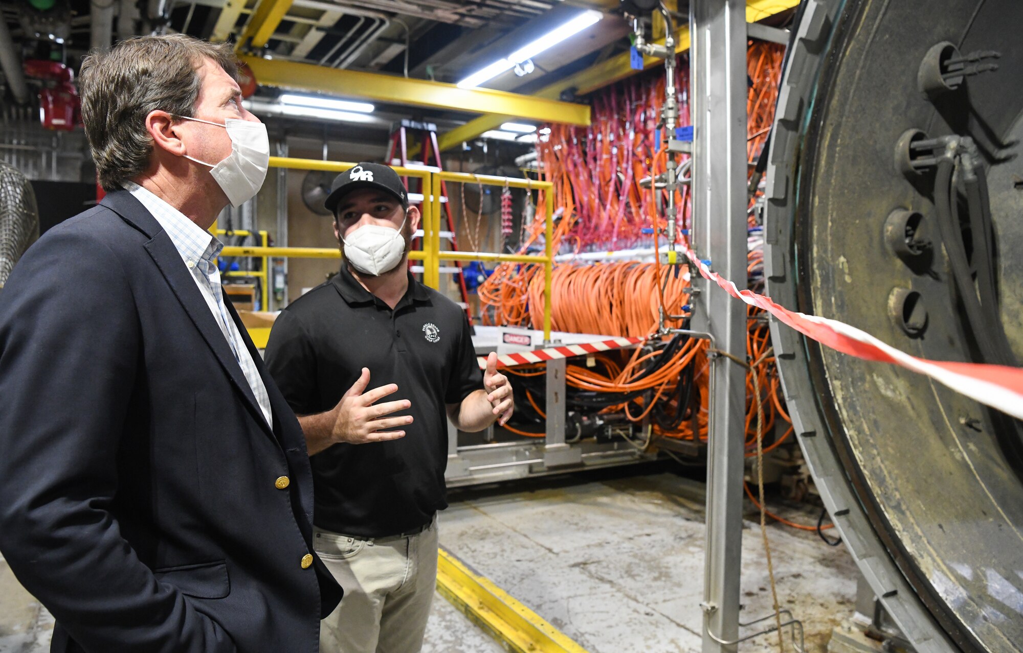 John Hile, right, an Arnold Engineering Development Complex (AEDC) test engineer, speaks with Sen. Bill Hagerty of Tennessee about the arc heaters used for high-temperature materials characterization and evaluation during a visit by the senator to the headquarters of AEDC, Arnold Air Force Base, Tenn., Aug. 23, 2021. Arc heaters allow for the testing of thermal protection systems in simulated environments representative of hypersonic flight. (U.S. Air Force photo by Jill Pickett)