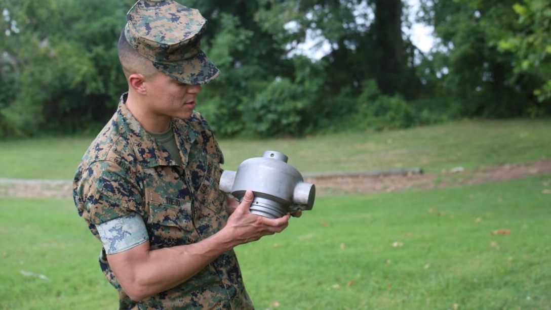 CWO2 Justin Trejo, a project officer with the Program Manager for Ammunition at Marine Corps Systems Command, displays a 3D-printed headcap for a rocket motor used to employ a M58 Mine Clearing Line Charge, July 21 at Marine Corps Base Quantico, Virginia. MCSC successfully developed and tested the headcap to support the Marine Corps’ mine-clearing missions.