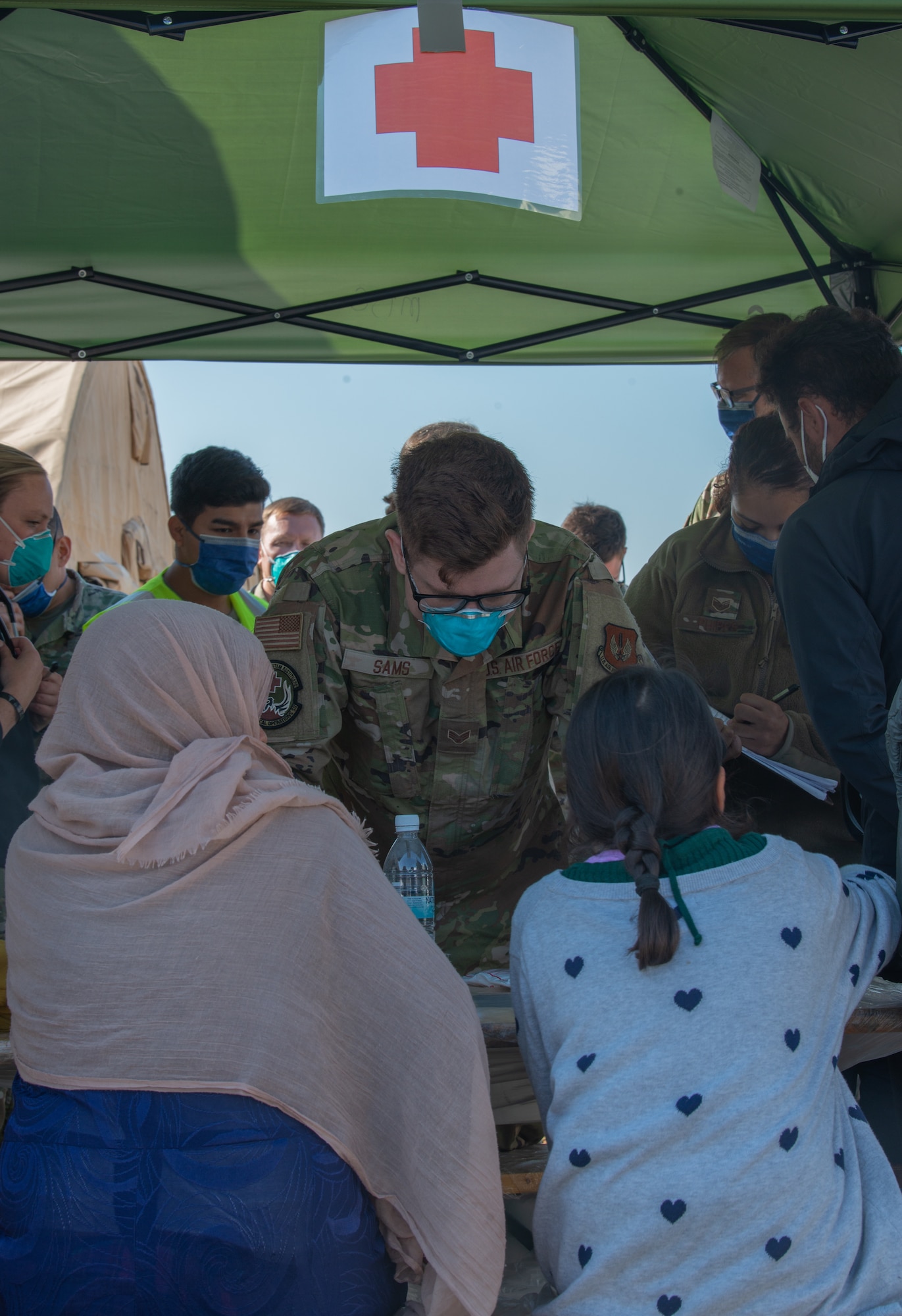 Airman distributes medical supplies to evacuees.