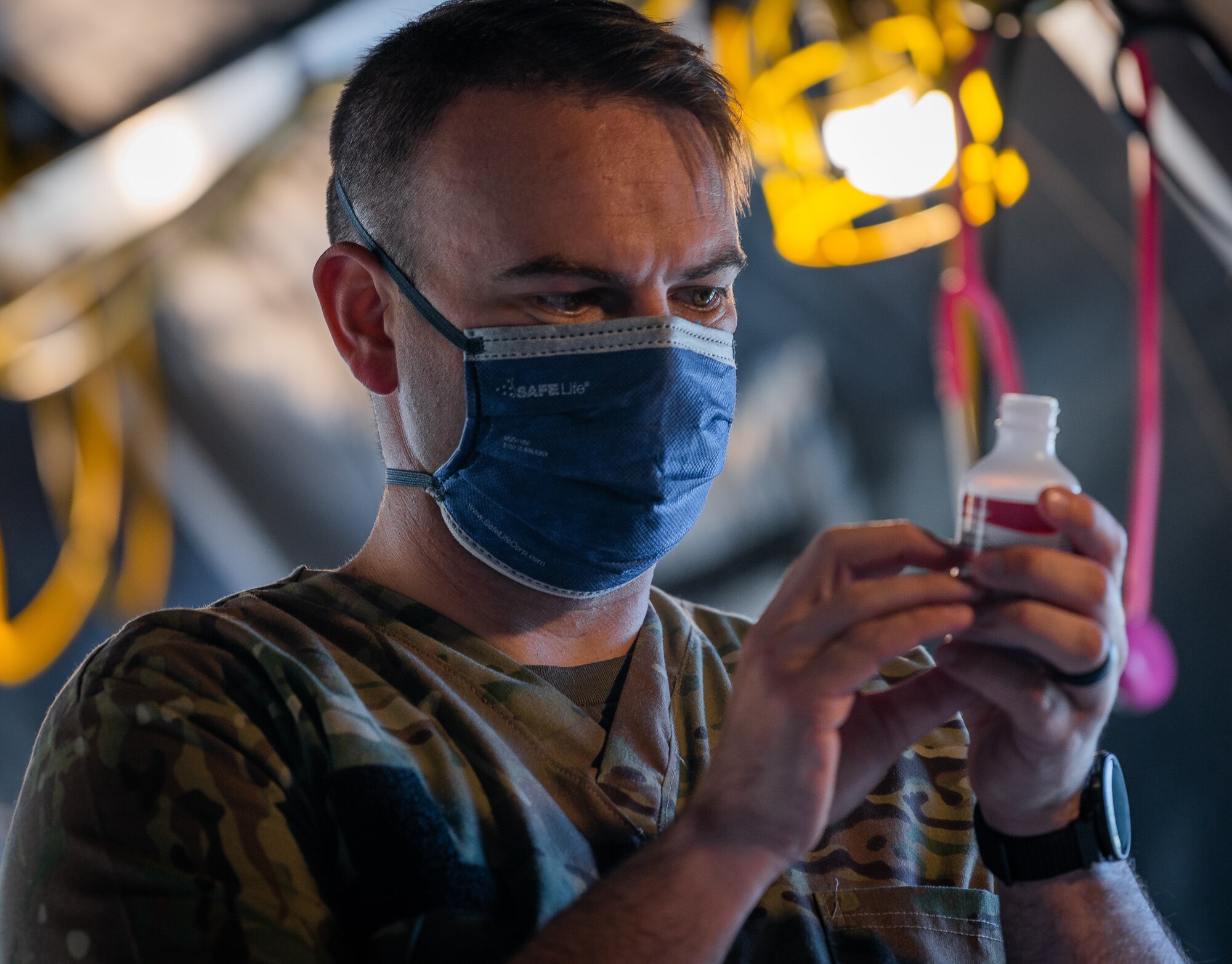 Soldier measures medication.