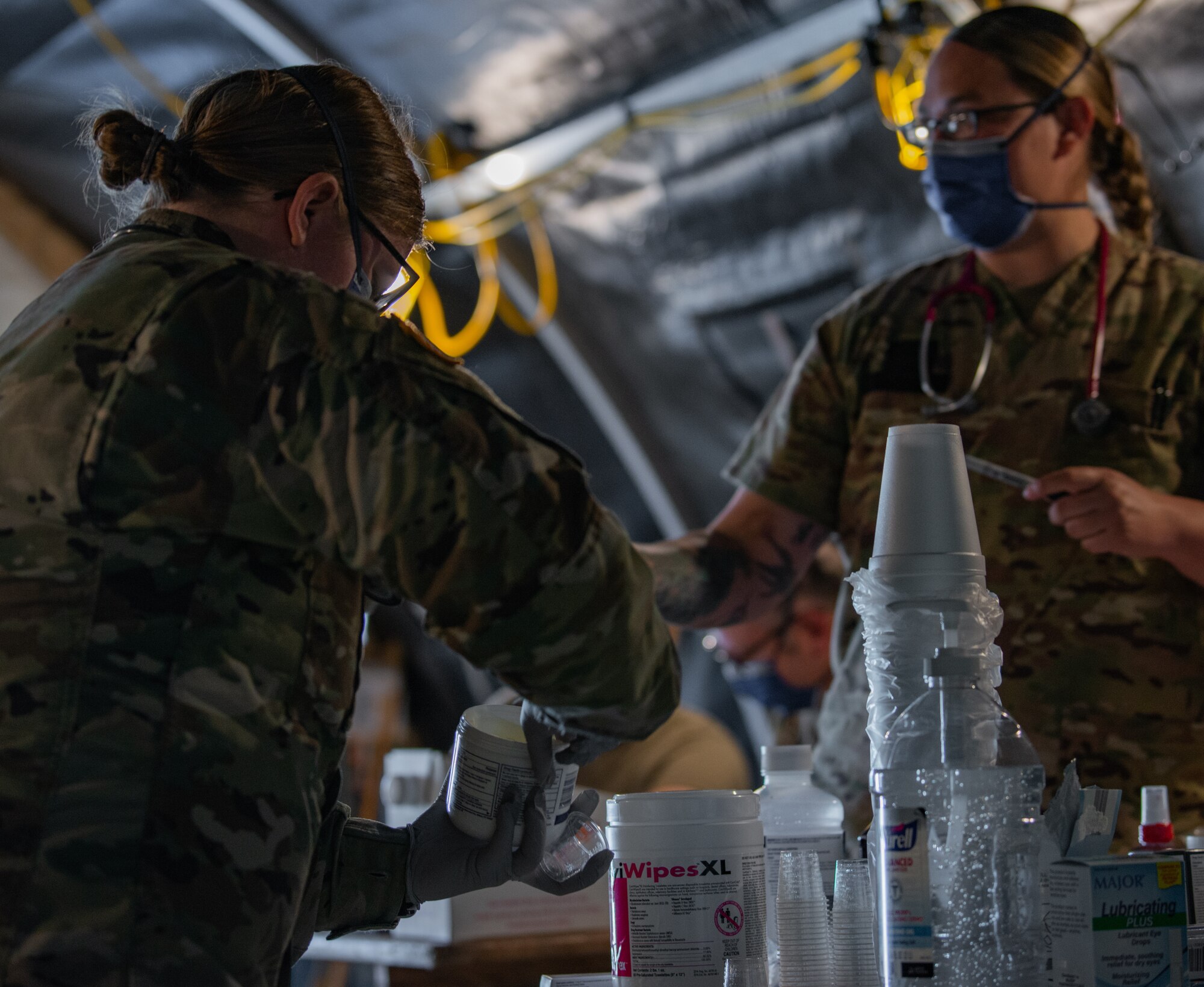 Airmen prepare medications for evacuees.