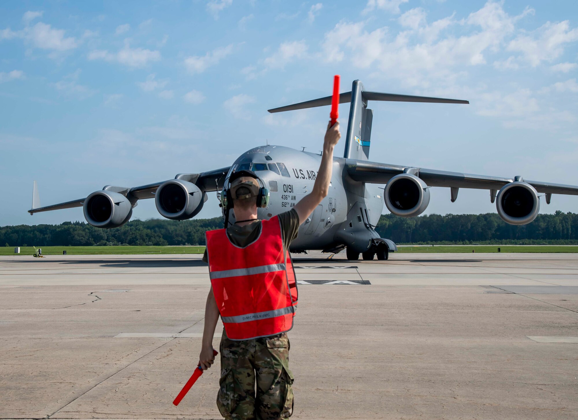 Airman 1st Class Tyler Davis, 736th Aircraft Maintenance Squadron crew chief, prepares to marshal a C-17 Globemaster III at Dover Air Force Base, Delaware, en route to support Afghanistan evacuation efforts, Aug. 24, 2021. Team Dover members donated infant formula, blankets and clothing in support of the safe evacuation of U.S. citizens, Special Immigrant Visa applicants and other vulnerable Afghans. (U.S. Air Force photo by Senior Airman Stephani Barge)