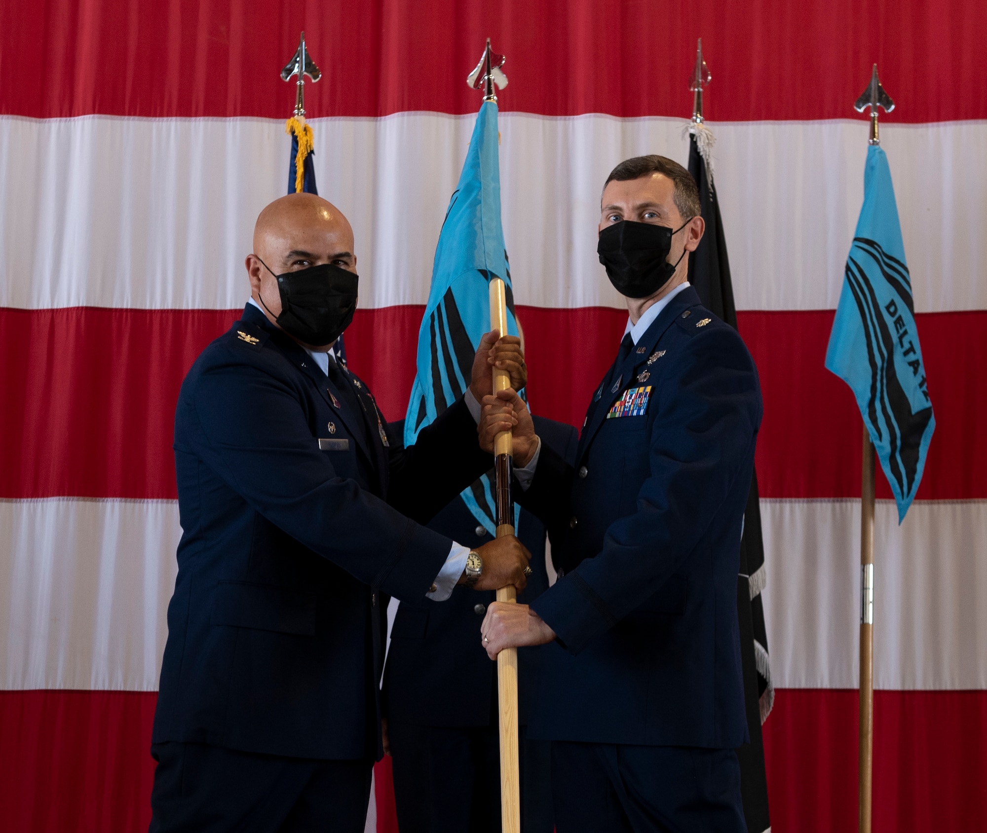 Commander hands off guidon during assumption of command ceremony