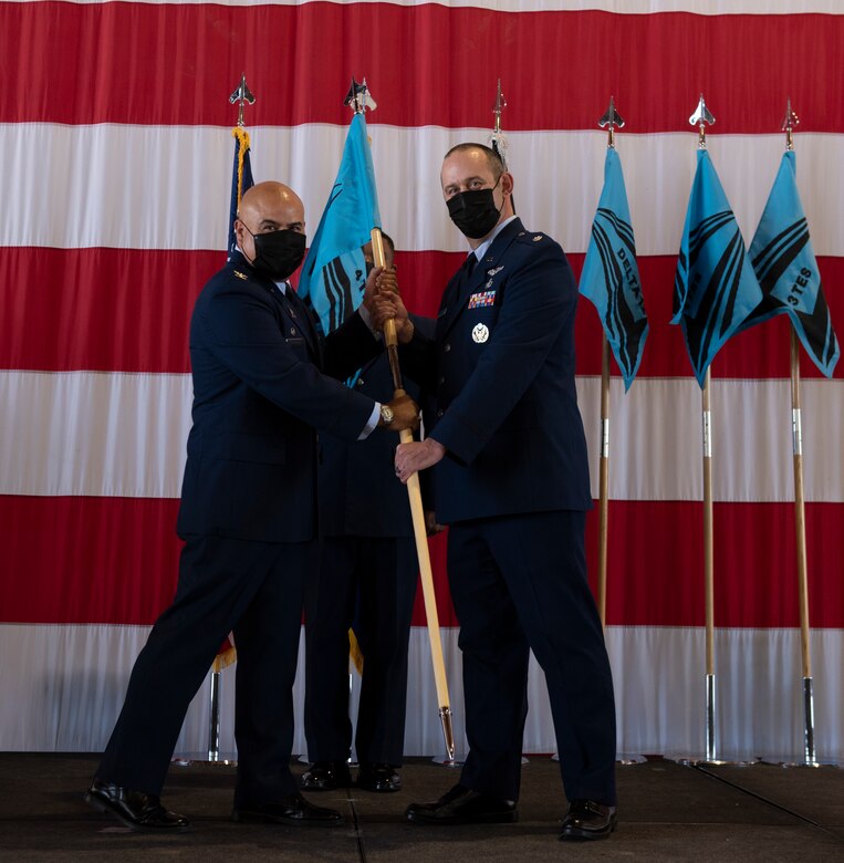 Commander hands off guidon during assumption of command ceremony