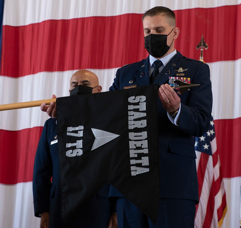 Commander unfurls old squadron flag during ceremony
