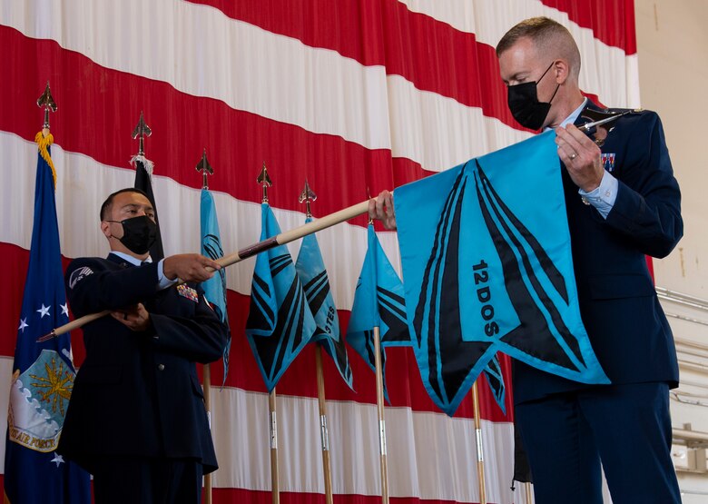 Commander unfurling new squadron flag